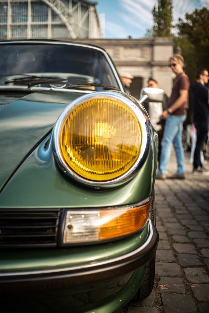 Phare jaune d’une Porsche 911 verte